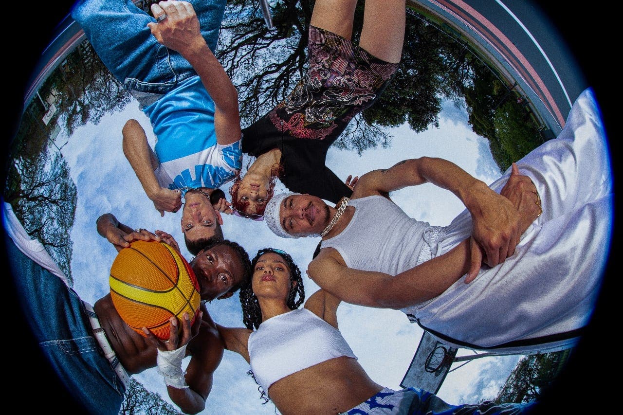 An ORBT crew huddled on a basketball court, shot through a fisheye lens